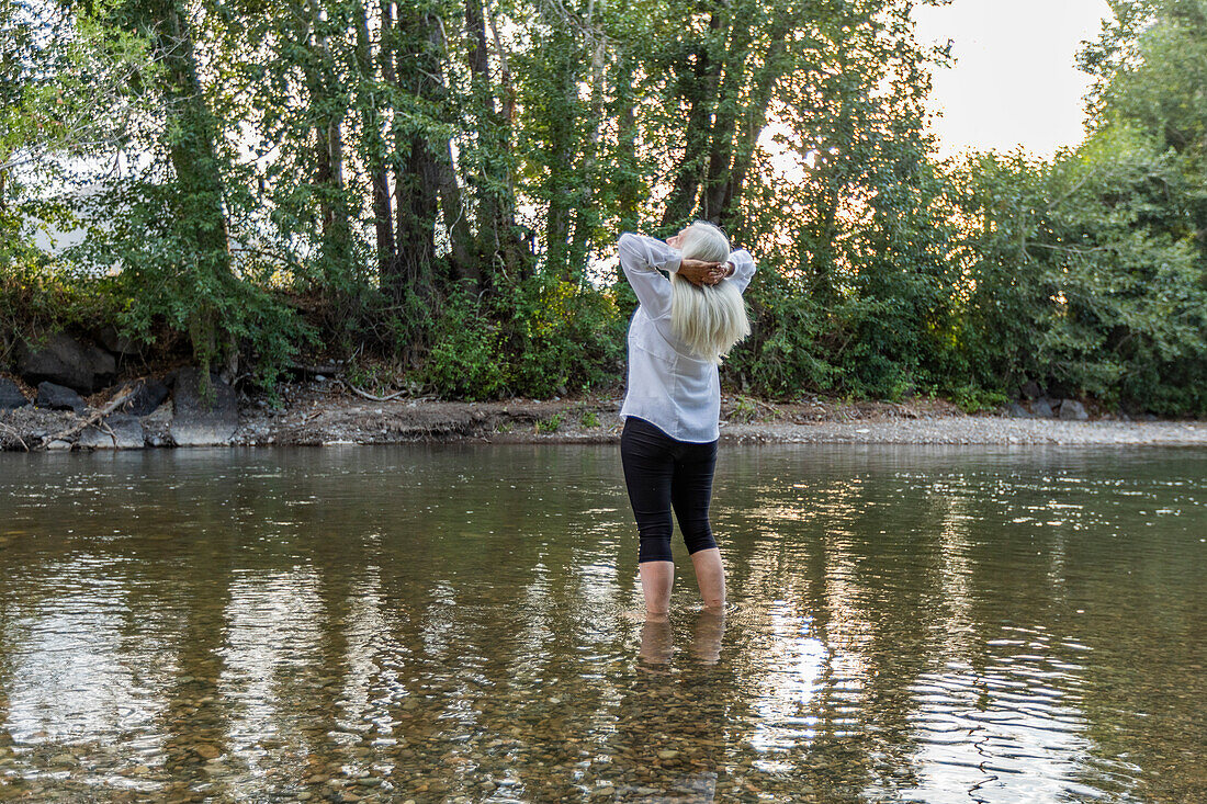 USA, Idaho, Bellevue, Senior woman standing in river