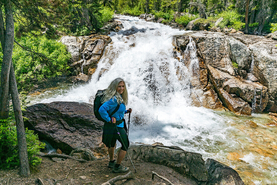 USA, Idaho, Stanley, Woman hiking by mountain waterfall near Sun Valley