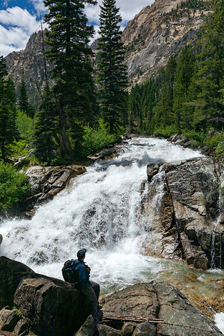 USA, Idaho, Stanley, Man hiking by mountain waterfall near Sun Valley