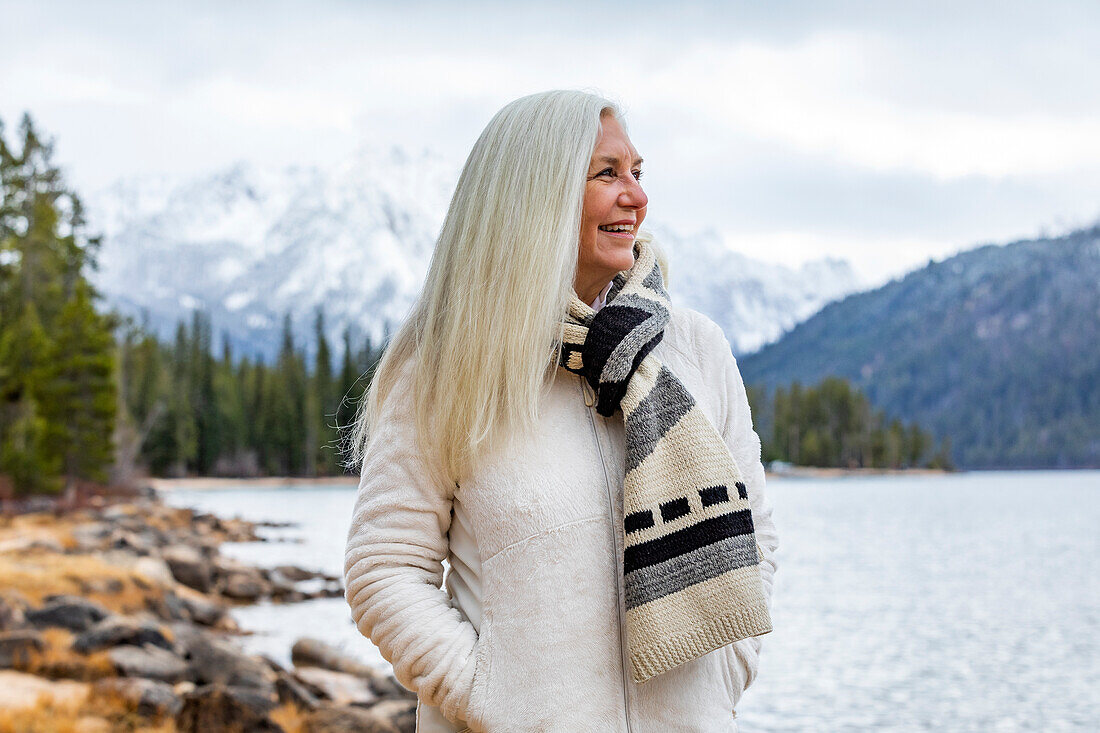 USA, Idaho, Stanley, Smiling senior woman at mountain lake