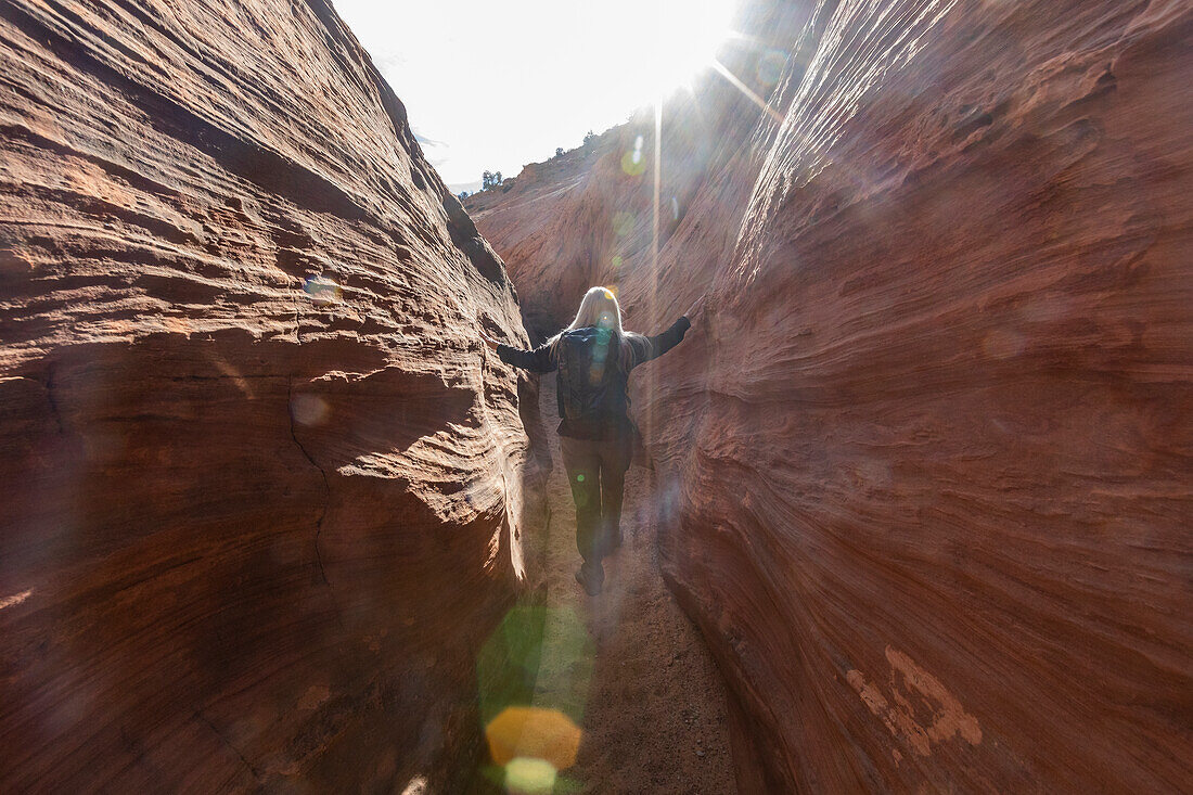 United States, Utah, Escalante, Senior hiker exploring slot canyon