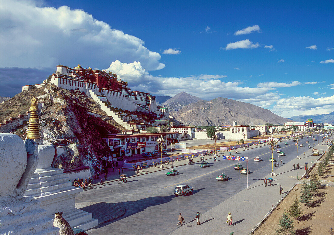 China, Tibet, Lhasa, Potala Palace and traffic on road