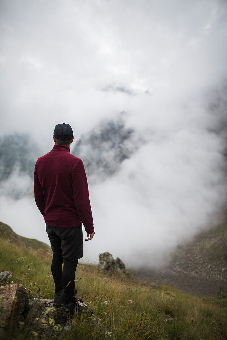 Switzerland, Appenzell, Man hiking in Swiss Alps