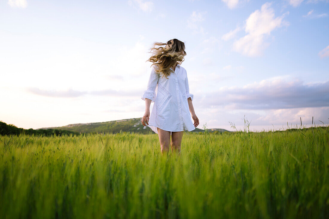 Young woman standing in agricultural field