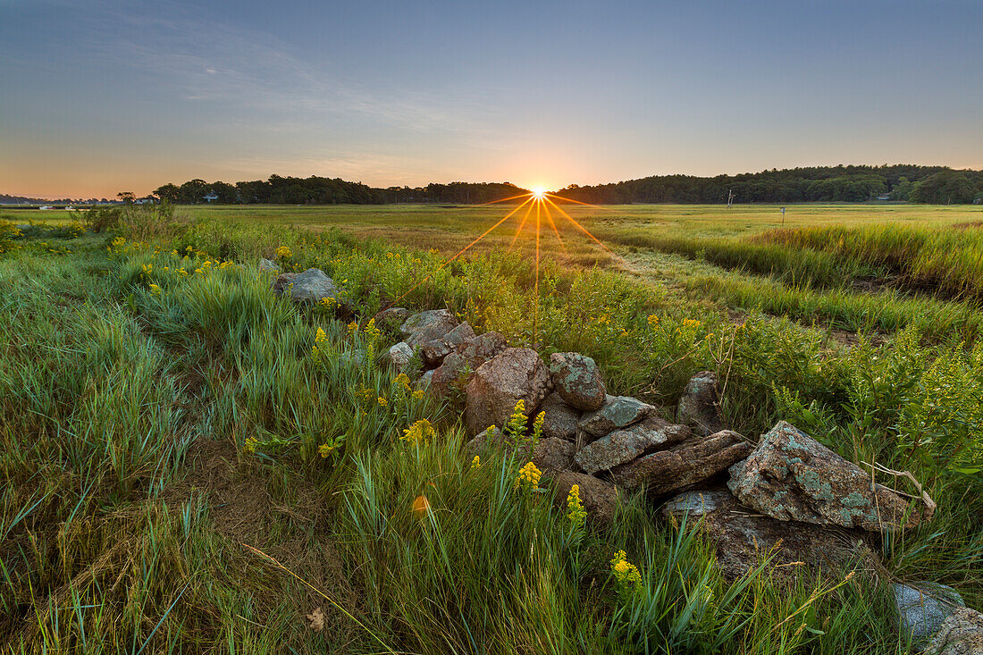 Sunrise over the salt marsh along the Essex River at the Cox Reservation in Essex, Massachusetts.
