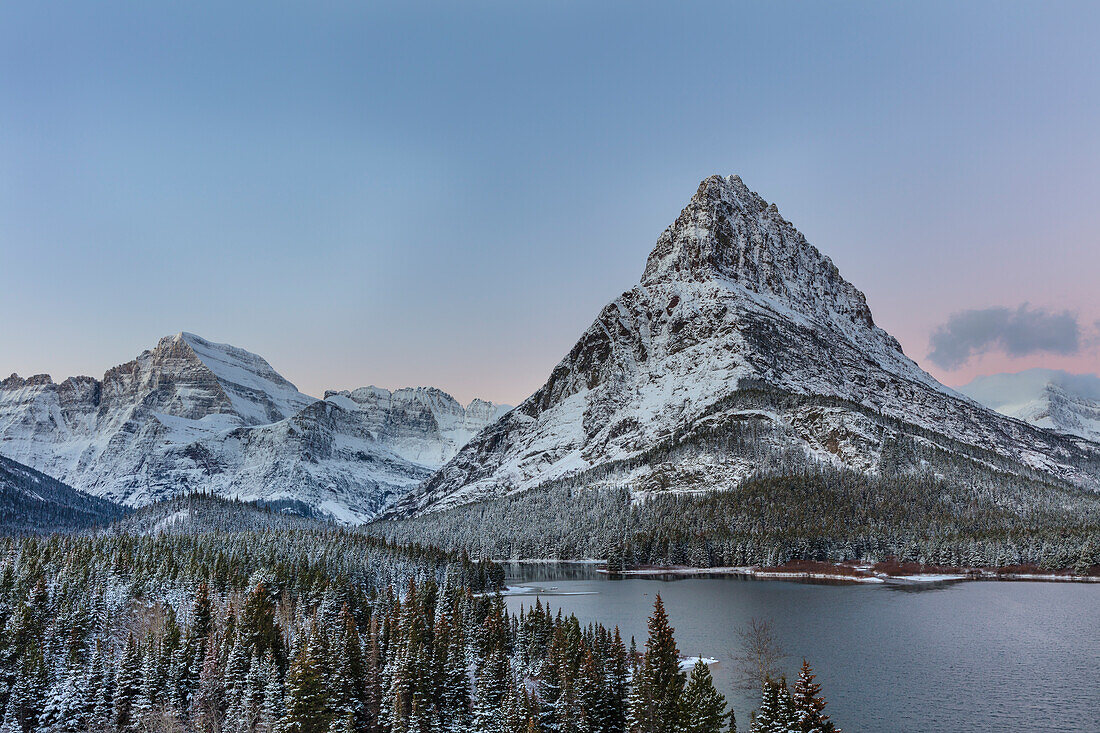 Grinnell Point and Mount Gould over Swift current Lake in early winter in Glacier National Park, Montana, USA