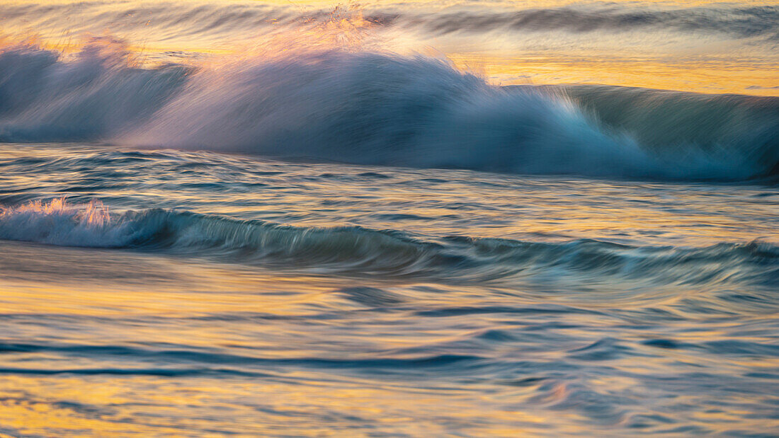 USA, New Jersey, Cape May National Seashore. Wave on beach at sunrise.