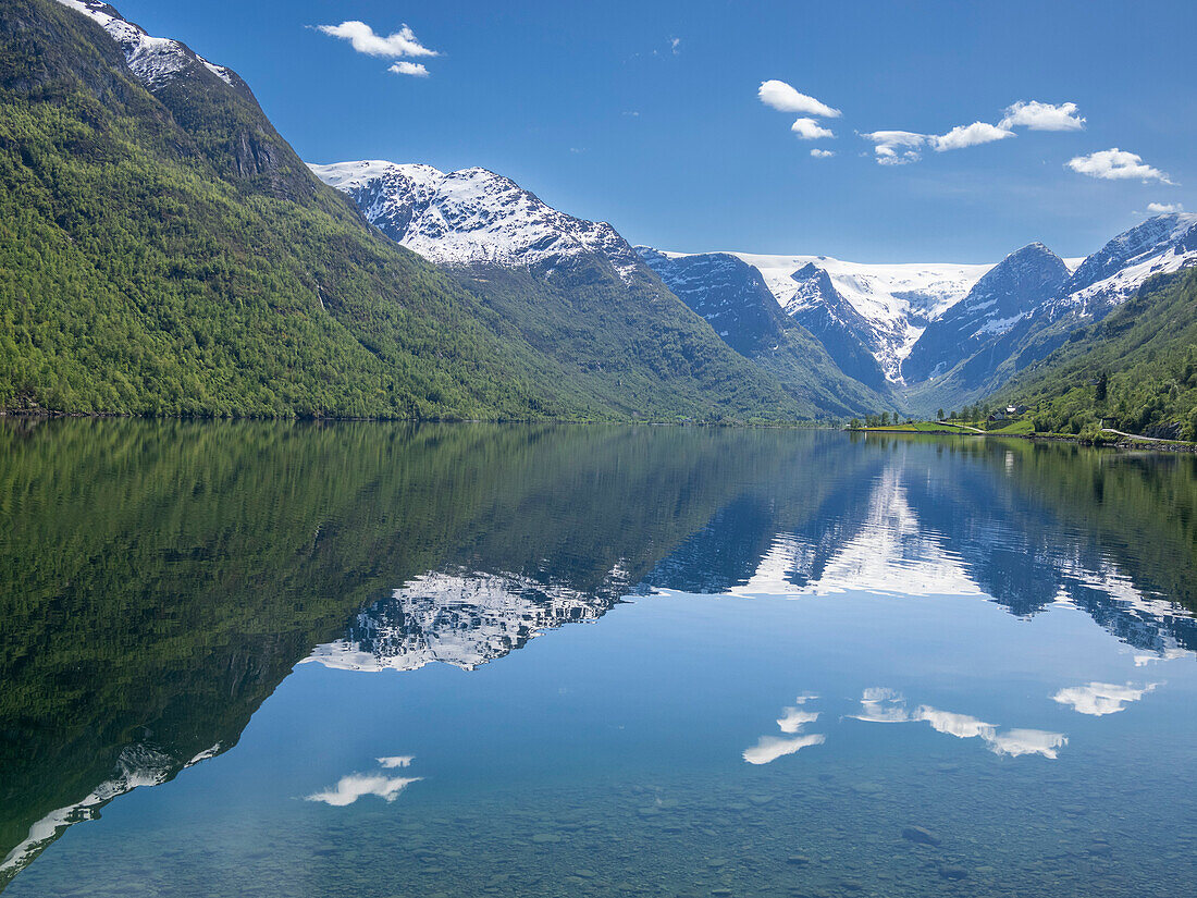 A view of snow-covered mountains and reflections in Lake Oldevatnet, within the Oldedalen River Valley, Vestland, Norway, Scandinavia, Europe