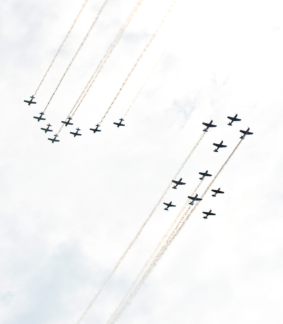 USA, Wisconsin, Oshkosh, AirVenture 2016, Formations of T-28 Trojans and Nanchang CJ-6A Aircraft Trailing smoke in head-on pass