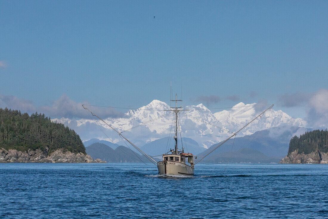 Commercial fishing boat in Inian Pass with the Fairweather Mountains behind, Southeast Alaska, United States of America, North America