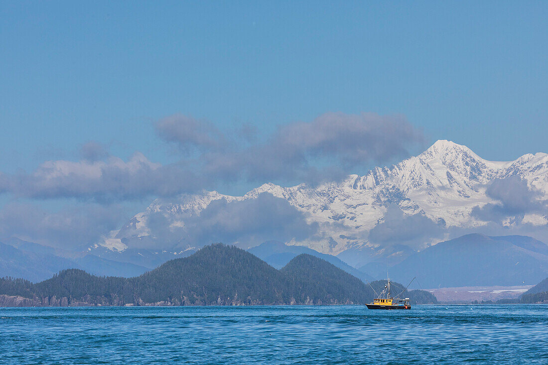 Commercial fishing boat in Inian Pass with the Fairweather Mountains behind, Southeast Alaska, United States of America, North America