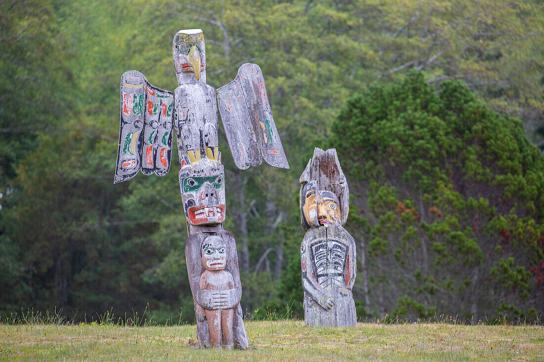 Kwakwaka'wakw totem poles in the cemetery in Alert Bay, Cormorant Island, British Columba, Canada, North America