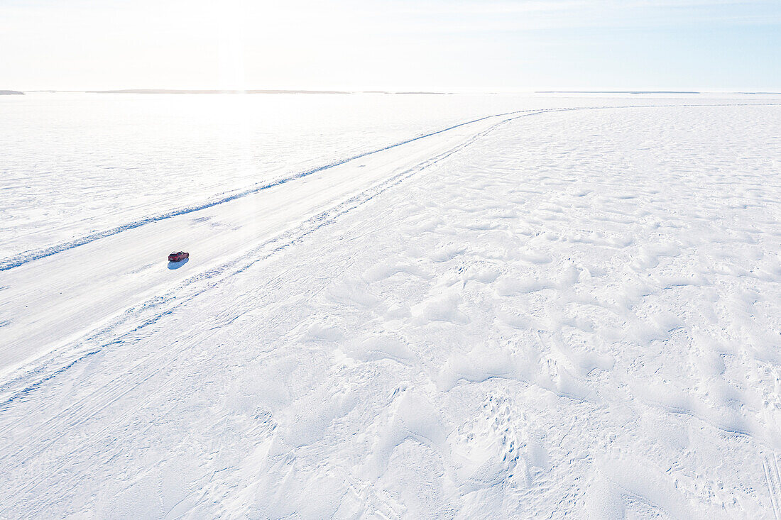 Aerial view of car driving on a slippery ice road on the frozen Arctic sea, Lulea, Norrbotten County, Lapland, Sweden, Scandinavia, Europe