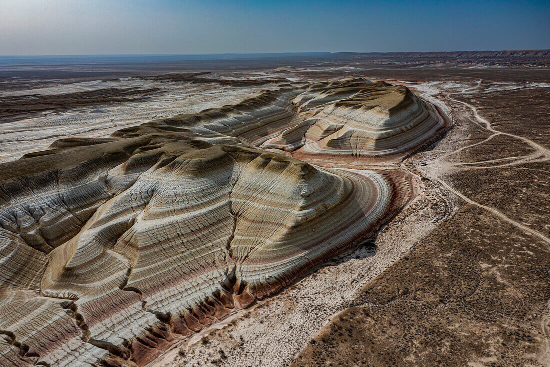 Aerial of multicoloured layers of sandstone, Kyzylkup, Mangystau, Kazakhstan, Central Asia, Asia