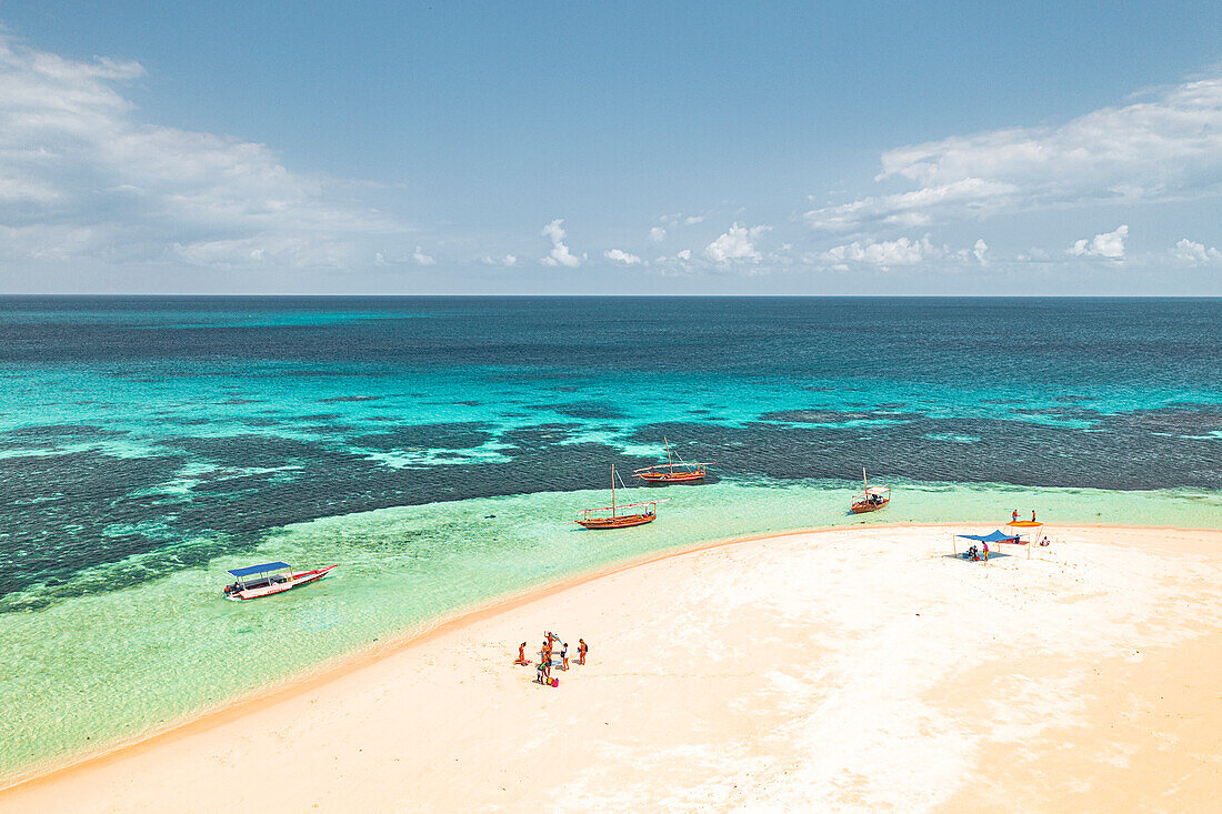 Tourists having fun on idyllic beach washed by the crystal water of Indian Ocean, aerial view, Kwale Island, Zanzibar, Tanzania, East Africa, Africa