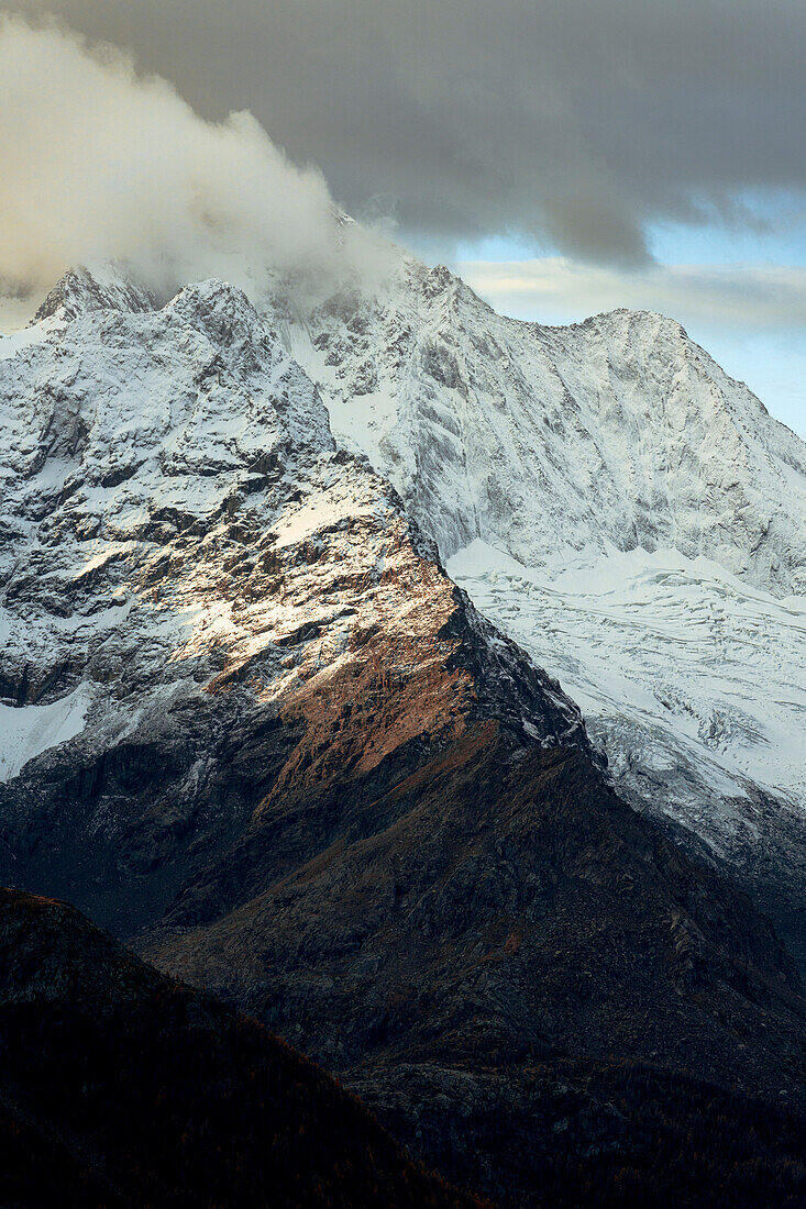 Majestic peak of Monte Disgrazia covered with snow in the autumn mist, Valmalenco, Sondrio province, Lombardy, Italy, Europe