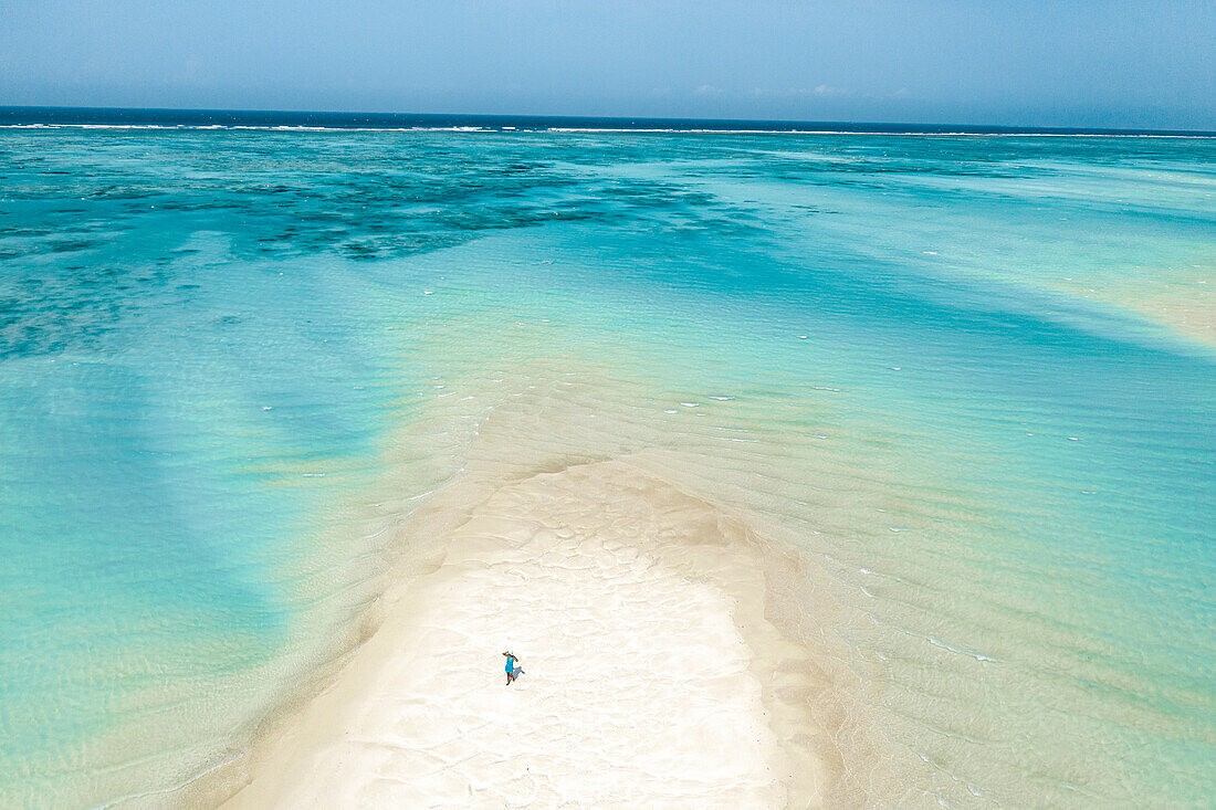 Luftaufnahme einer Frau, die bei Ebbe auf einer Sandbank läuft, Nungwi, Sansibar, Tansania, Ostafrika, Afrika