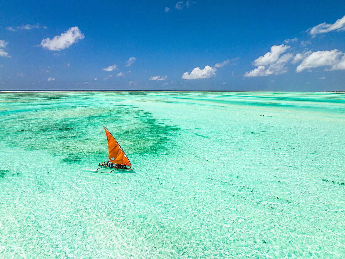 Aerial view of a dhow sailing in the transparent lagoon, Paje, Jambiani, Zanzibar, Tanzania, East Africa, Africa