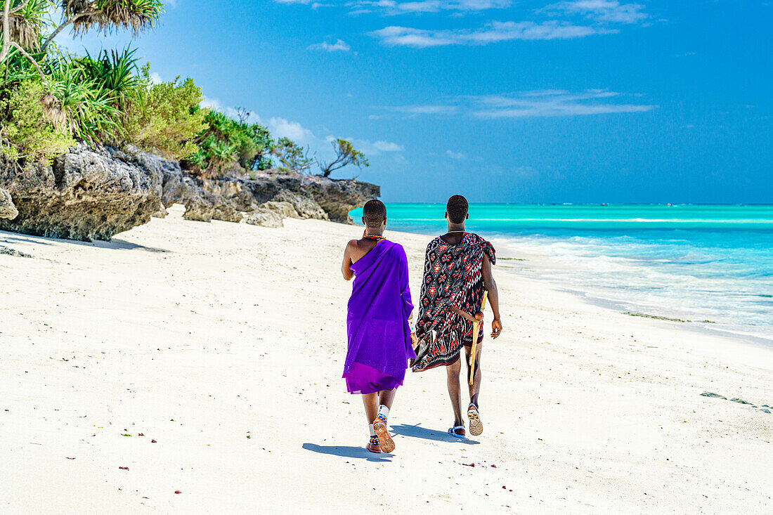 Couple of Maasai warriors enjoying walking on exotic beach, Zanzibar, Tanzania, East Africa, Africa