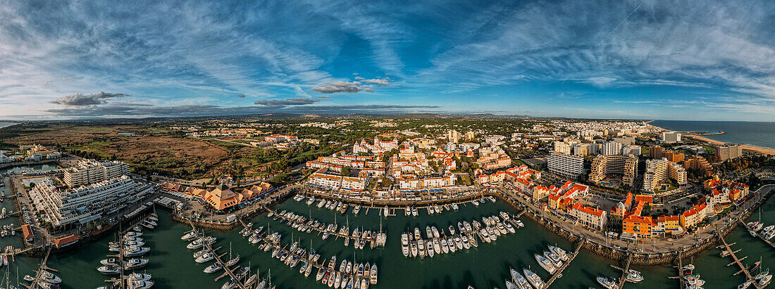 Aerial view of the tourist Portuguese town of Vilamoura, with yachts and sailboats moored in the port on the marina, Algarve, Portugal, Europe