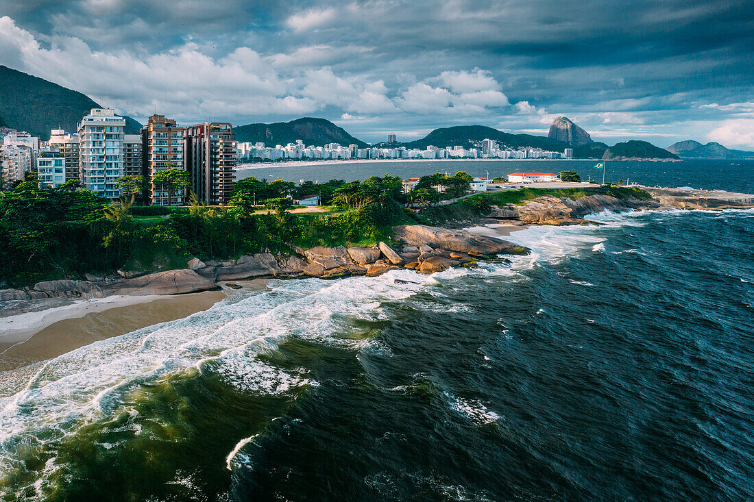 Drohnenaufnahme des Arpoador-Abschnitts des Ipanema-Strands mit Copacabana und Zuckerhut im Hintergrund, Rio de Janeiro, Brasilien, Südamerika
