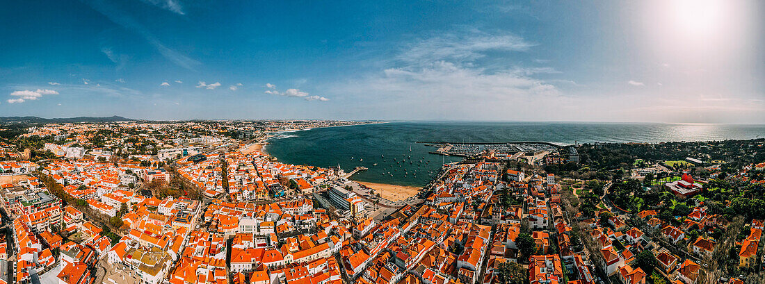 Aerial drone panoramic view of Cascais historic centre with the iconic Bay and Ribeira Beach, 30km west of Lisbon on the Portuguese Riviera, Cascais, Portugal, Europe