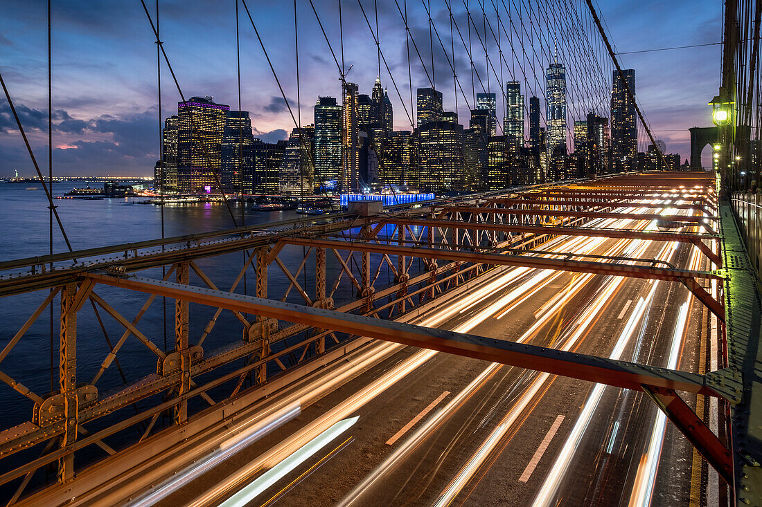 Traffic crossing the Brooklyn Bridge and the Manhattan skyline at night, Manhattan, New York, United States of America, North America