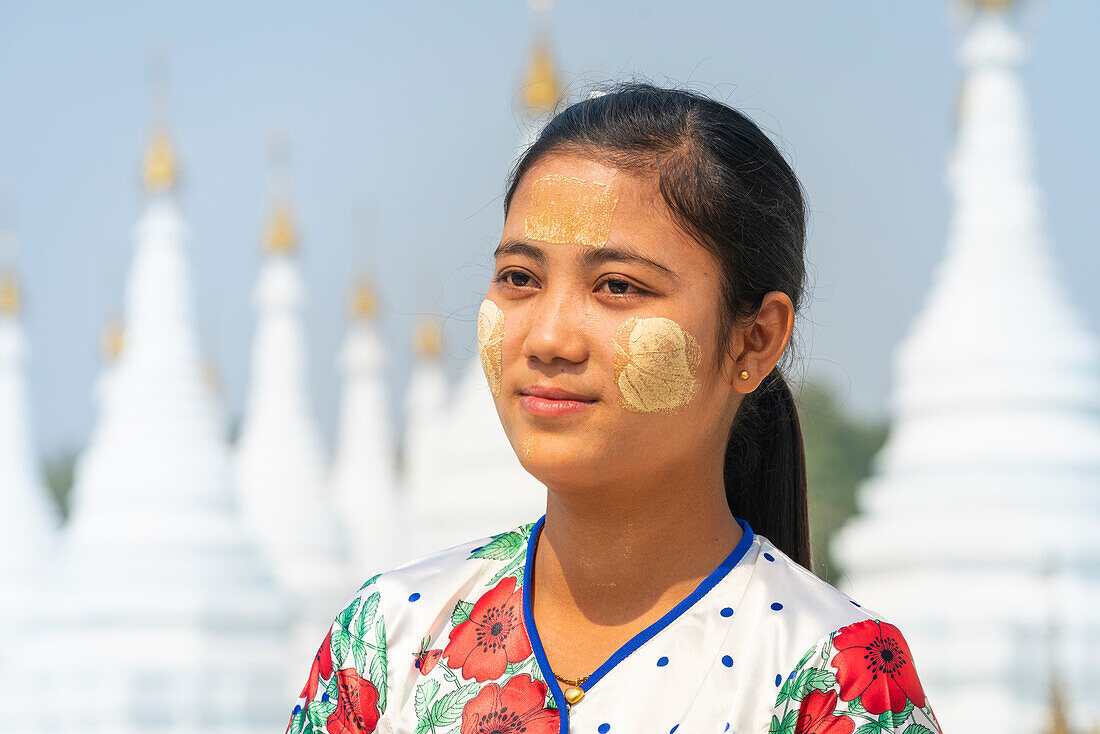 Young Burmese woman at white stupas of Sanda Muni Pagoda (Sanda Mu Ni) (Sandamani) (Sandamuni), Mandalay, Myanmar (Burma), Asia