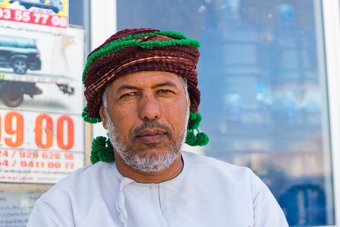 Portrait of Omani man with headwear looking at camera, Hasik, Dhofar Governorate, Oman, Middle East