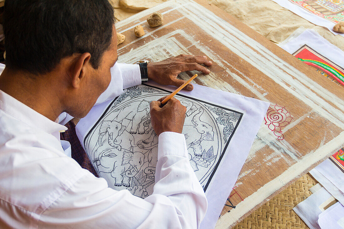 Artist drawing design featuring elephants on canvas, Bagan, Myanmar (Burma), Asia