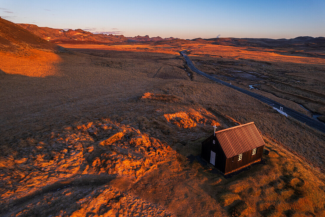 View from above of the small black wooden church of krysuvikurkirkja, at sunrise, Krysuvik, Hafnarfjardarkaupstadur municipality, Reykjanes peninsula, Capital region, Iceland, Polar Regions