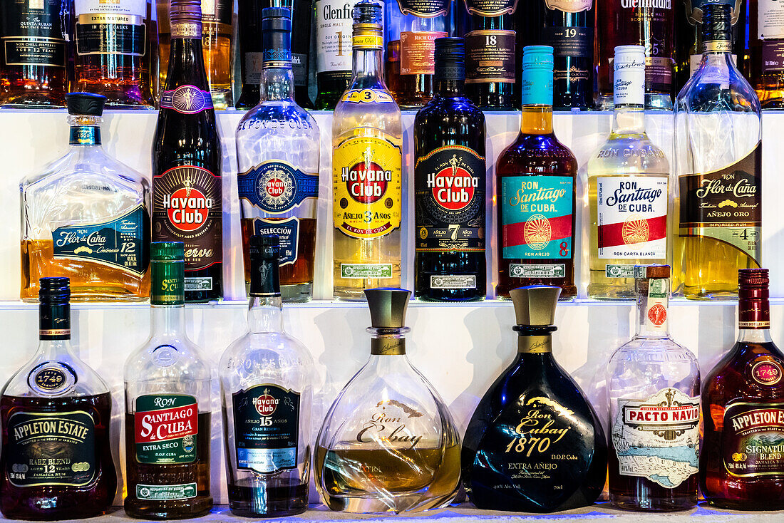 Lines of bottles of ubiquitous rum, Havana, Cuba, West Indies, Caribbean, Central America