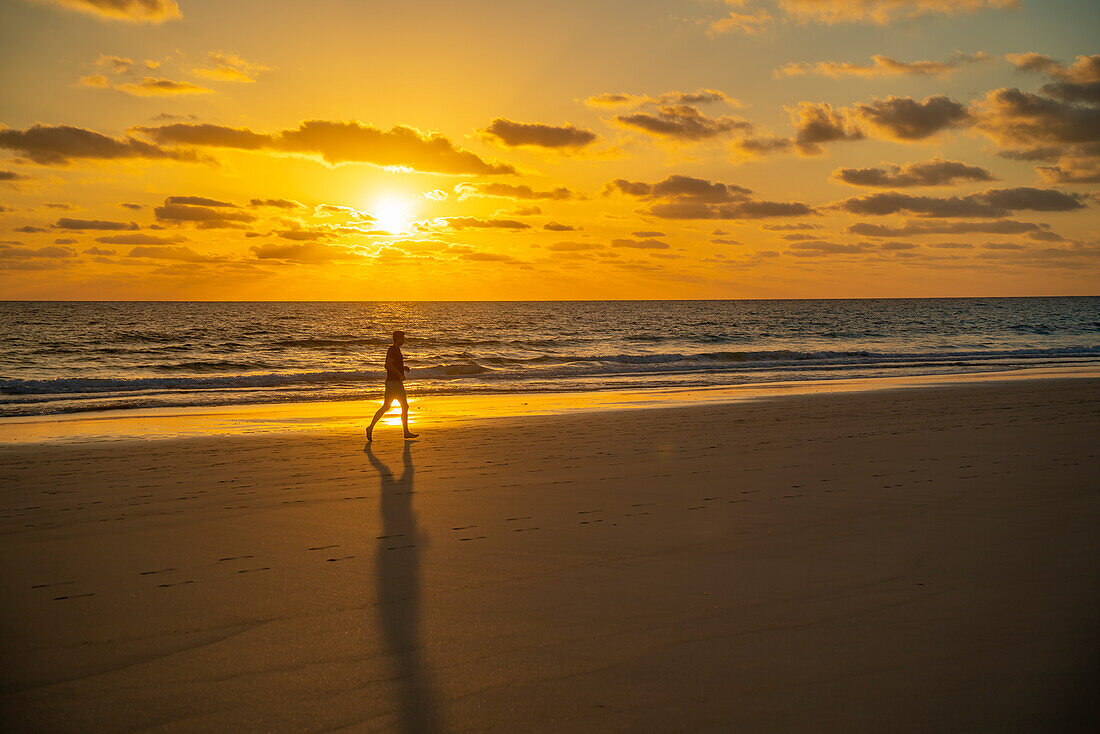 View of beach, jogger and the Atlantic Ocean at sunrise, Corralejo Natural Park, Fuerteventura, Canary Islands, Spain, Atlantic, Europe