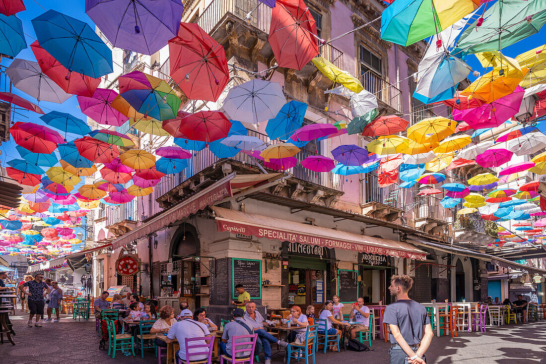 View of colourful umbrellas and restaurants on Via Gisira, Catania, Sicily, Italy, Mediterranean, Europe