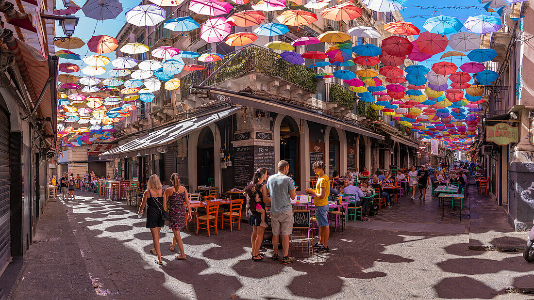 View of colourful umbrellas and restaurants on Via Gisira, Catania, Sicily, Italy, Mediterranean, Europe