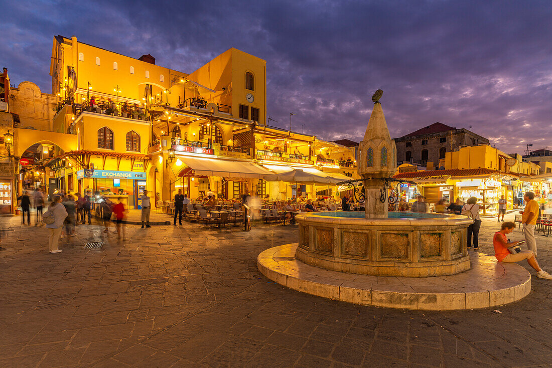 View of fountain in Hippocrates Square at dusk, Old Rhodes Town, UNESCO World Heritage Site, Rhodes, Dodecanese, Greek Islands, Greece, Europe