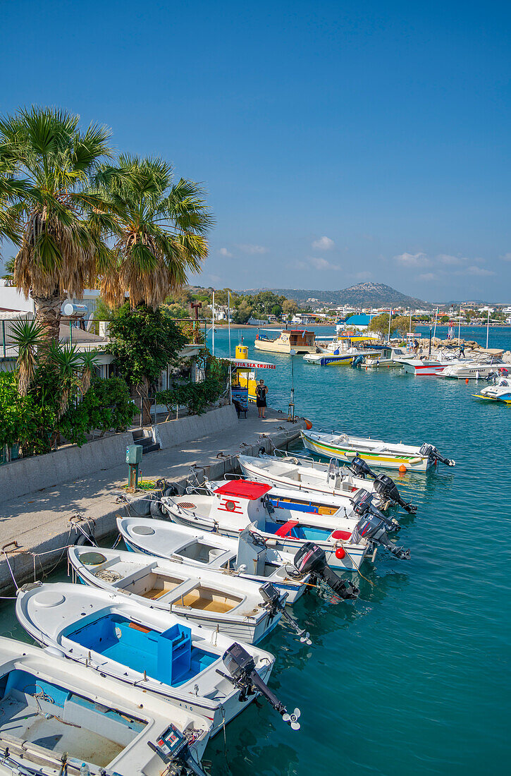 View of Faliraki Harbour and little white chapel, Faliraki, Rhodes, Dodecanese Island Group, Greek Islands, Greece, Europe