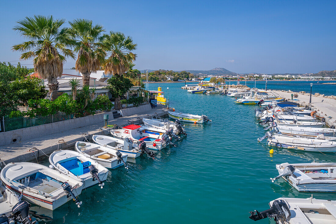 View of Faliraki Harbour and little white chapel, Faliraki, Rhodes, Dodecanese Island Group, Greek Islands, Greece, Europe