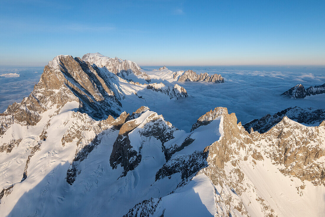 Aerial view of Grandes Jorasses and Mont Blanc in background during sunrise, Courmayeur, Aosta Valley, Italy, Europe