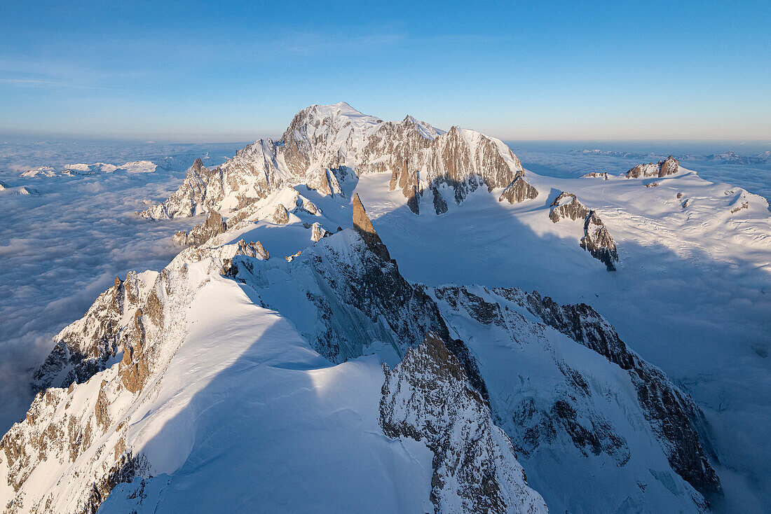 Aerial view of snowy peaks of Mont Blanc and Dent du Geant during sunrise, Courmayeur, Aosta Valley, Italy, Europe