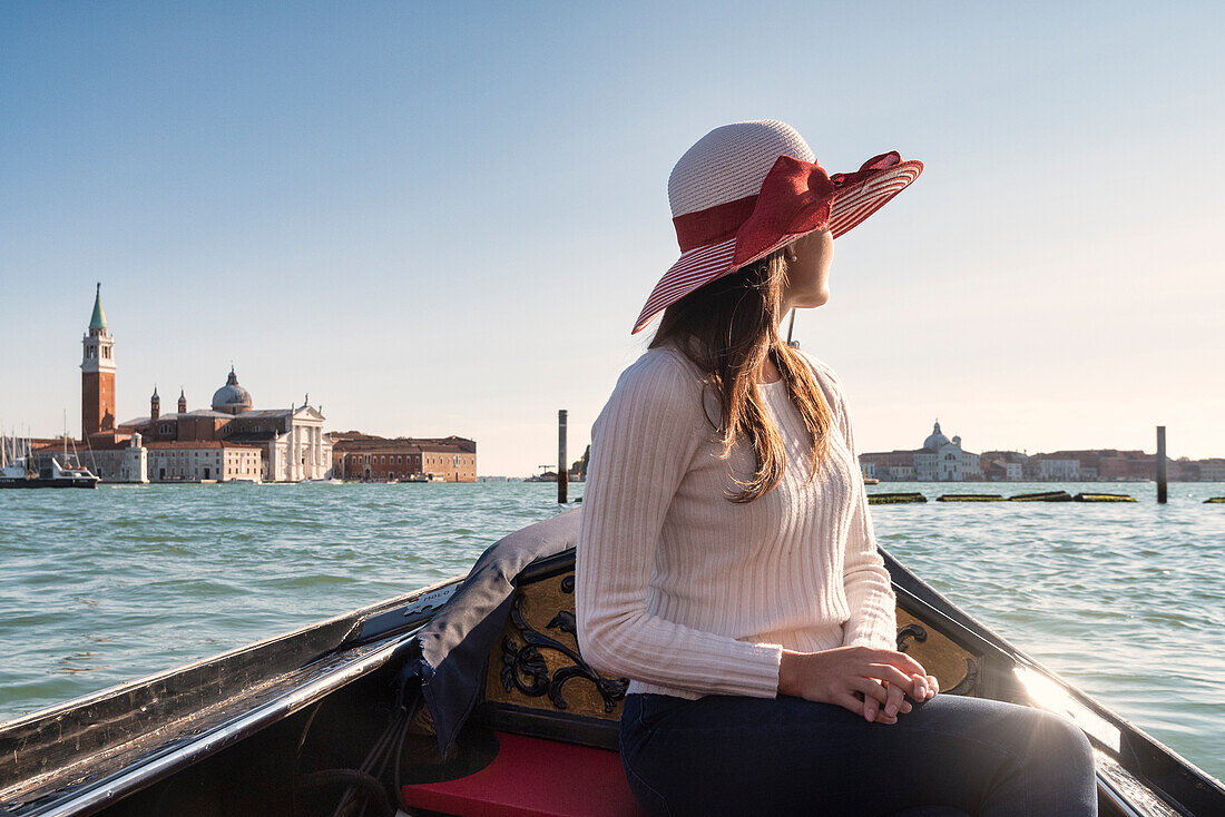 Young girl in a gondola tour in Venice, Veneto, Italy, Europe
