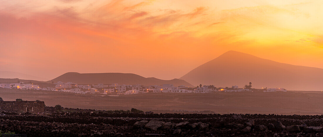 View of Tinajo and mountains in background at sunset, Tinajo, Lanzarote, Las Palmas, Canary Islands, Spain, Atlantic, Europe