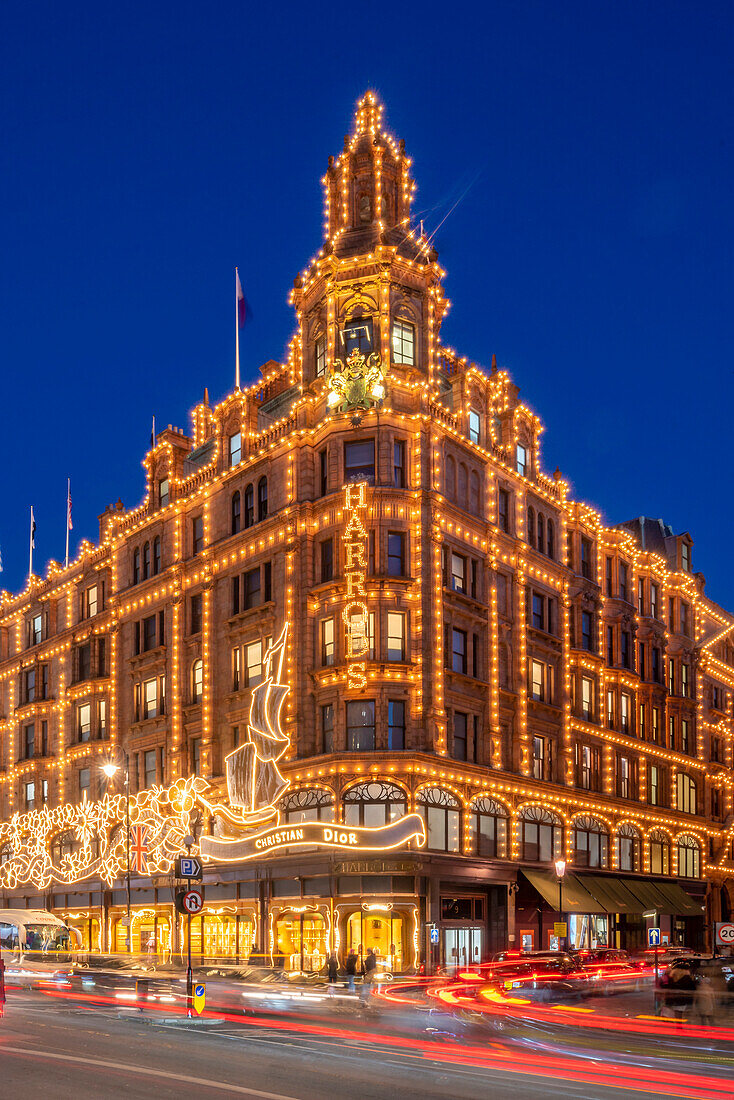 View of Harrods department store illuminated at dusk, Knightsbridge, London, England, United Kingdom, Europe