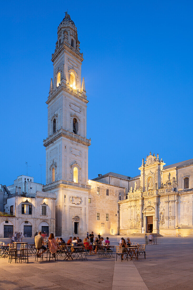 Floodlit campanile and cathedral with cafes at night in the Piazza del Duomo, Lecce, Puglia, Italy, Europe