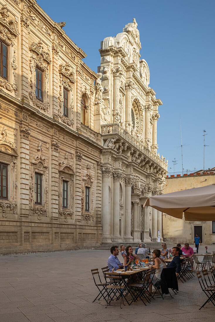 Basilica di Santa Croce and cafe on Via Umberto 1 in late afternoon, Lecce, Puglia, Italy, Europe