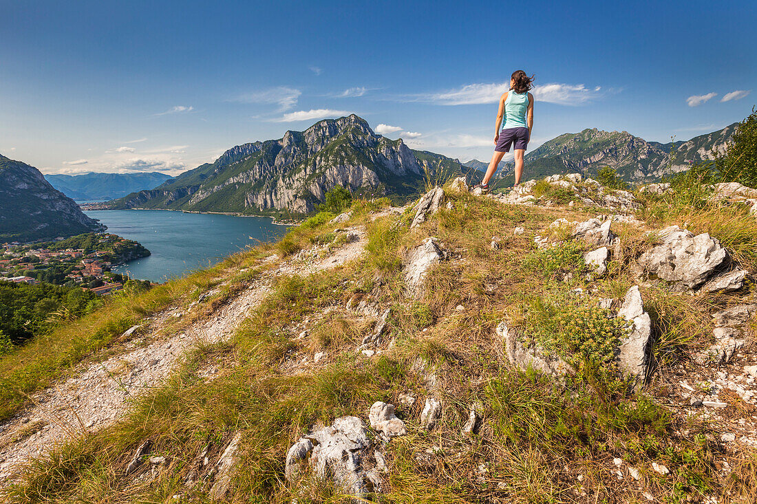 A hiker looks Coltignone mount and lake Como from Pian Sciresa, lake Como, Lecco province, Lombardy, Italy, Europe (MR)