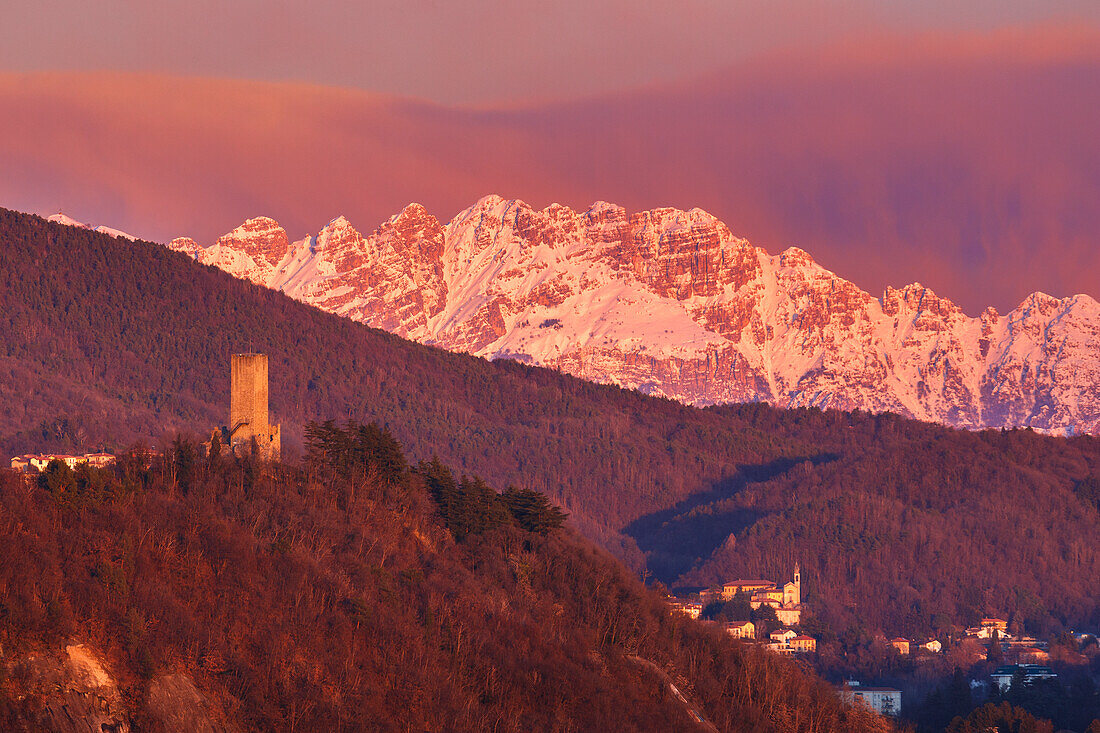 Sunset on Baradello tower (Como city) and Resegone mount (Lecco province), lake Como, Lombardy, Italy, Europe
