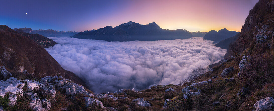 Panoramic of lake Como (ramo di Lecco) covered by the fog at sunrise, Grigna group, Lecco and Como province, Lombardy, Italy, Europe