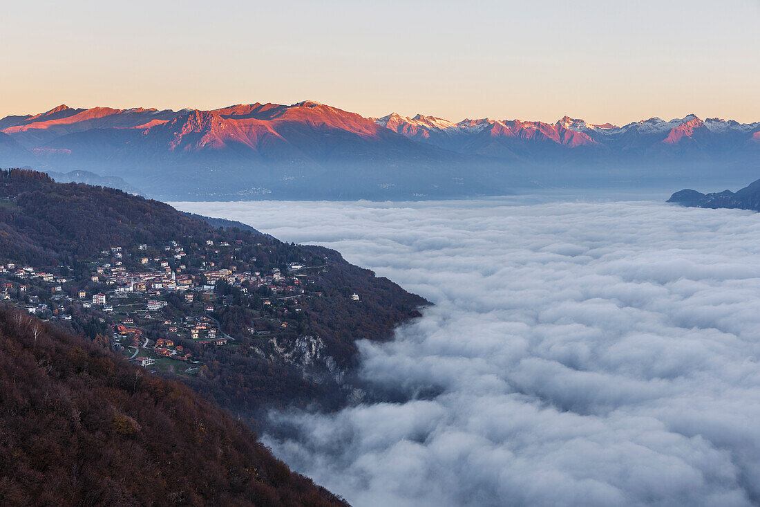 A view of lake Como (ramo di Lecco) covered by the fog at sunrise, from Civenna village to Valtellina mountains, Como and Lecco province, Lombardy, Italy, Europe