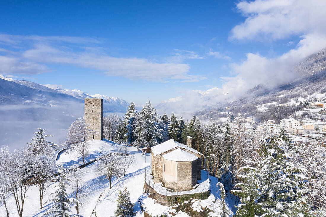 The tower of Teglio and little church of Santo Stefano after spring snowfall, Teglio, Valtellina, Province of Sondrio, Lombardy, Italy, Europe